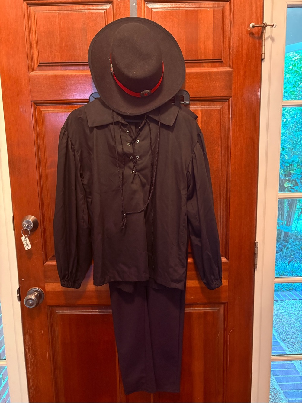 Unisex black historical costume lace up shirt, black stretchy pants with hat